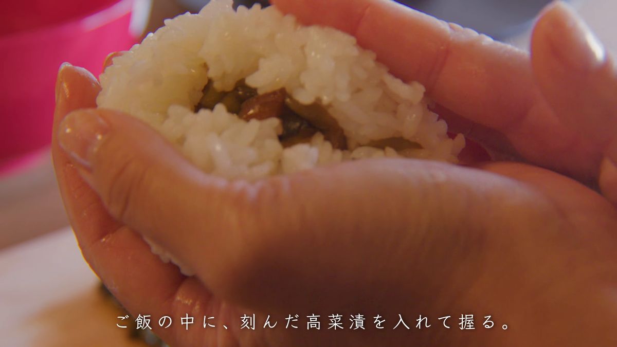 刻んだ高菜を入れたご飯を手のひらで握る