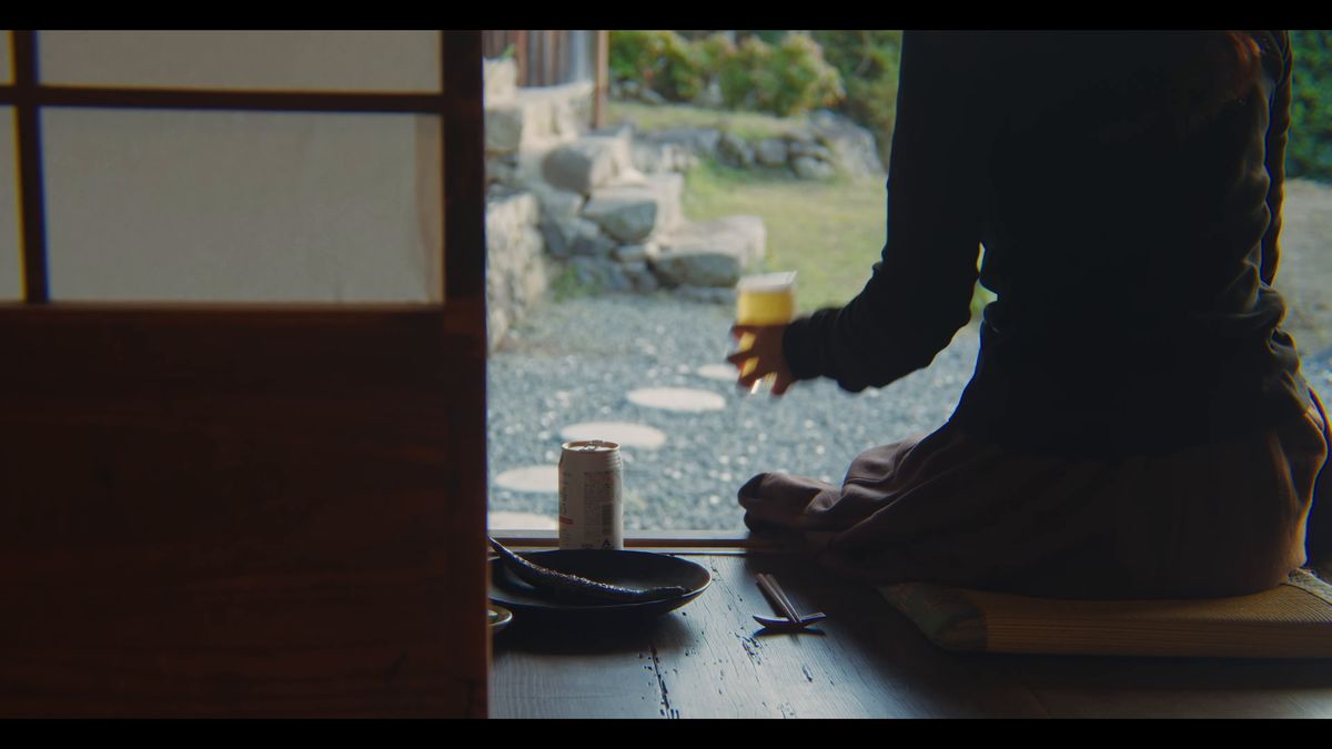 窓辺でグラスを手にくつろぐ