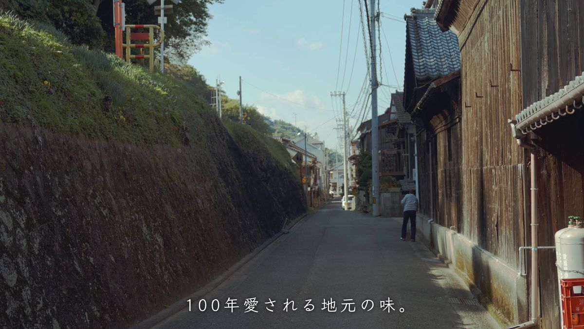 石垣の路地を歩く後ろ姿