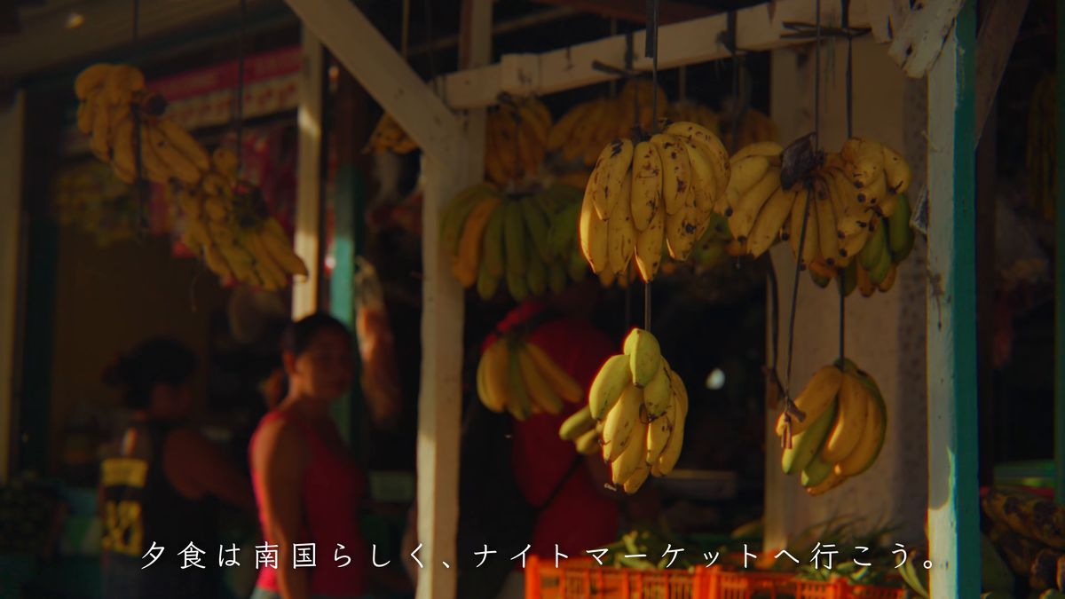 バナナの房が吊るされた夕方の店先