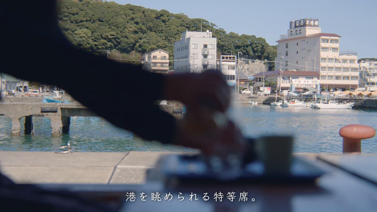 港を前にビールをグラスに注ぐ
