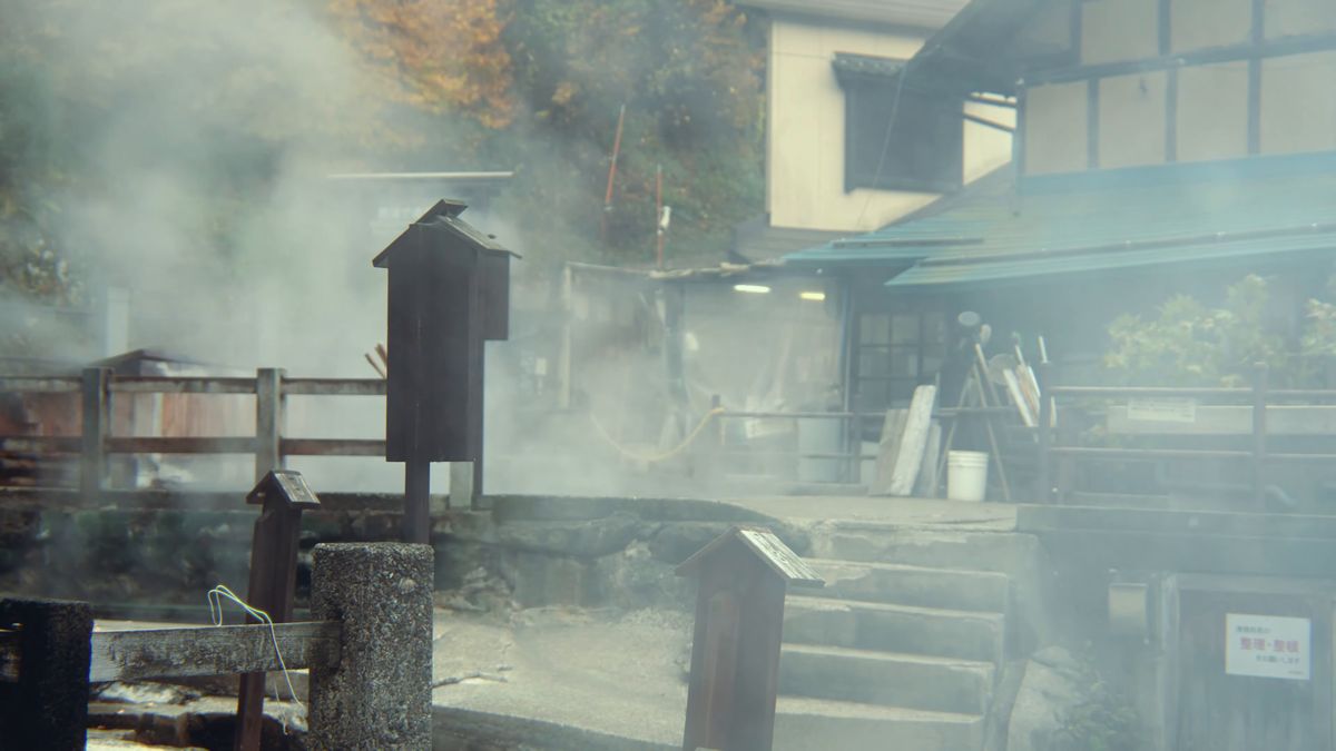 湯けむりの中の麻釜の木造の建物