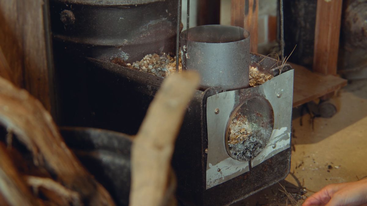 A rocket stove stacked with driftwood