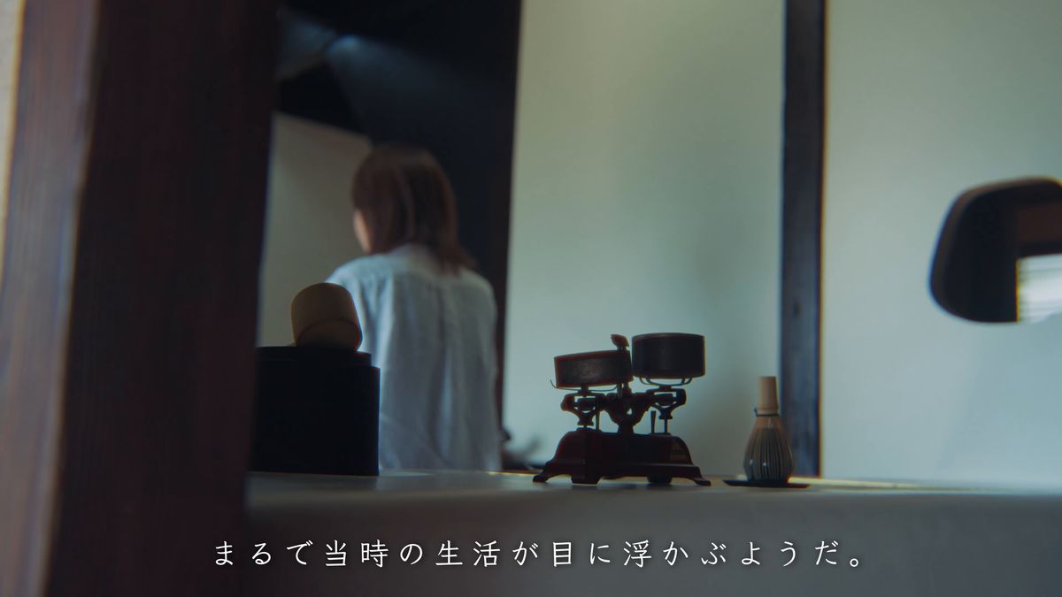 天秤ばかりの向こうのカウンターに座る後ろ姿