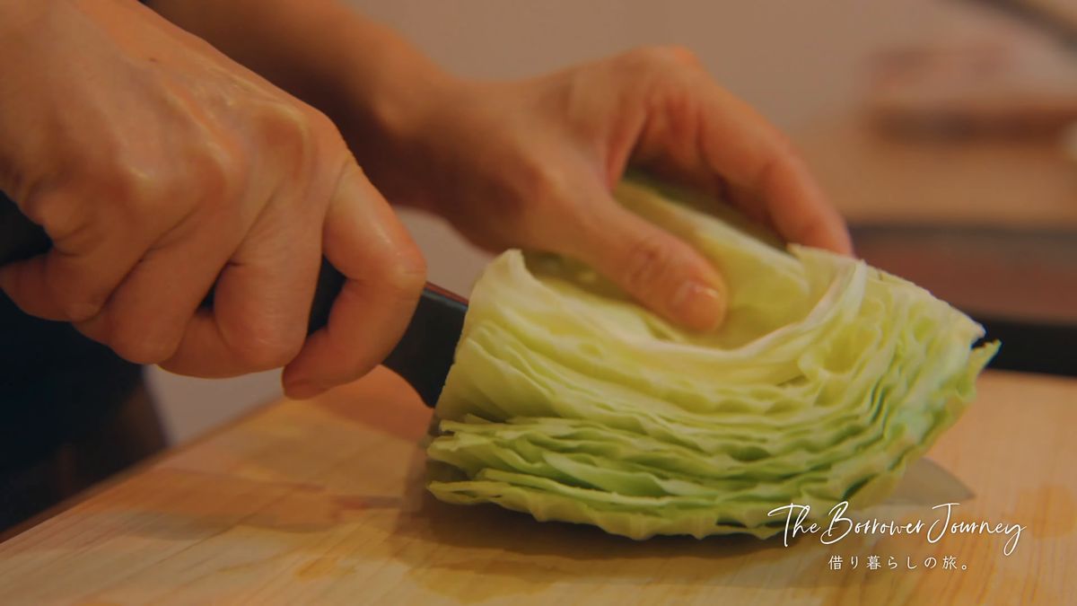 まな板の上でキャベツを半分に切る