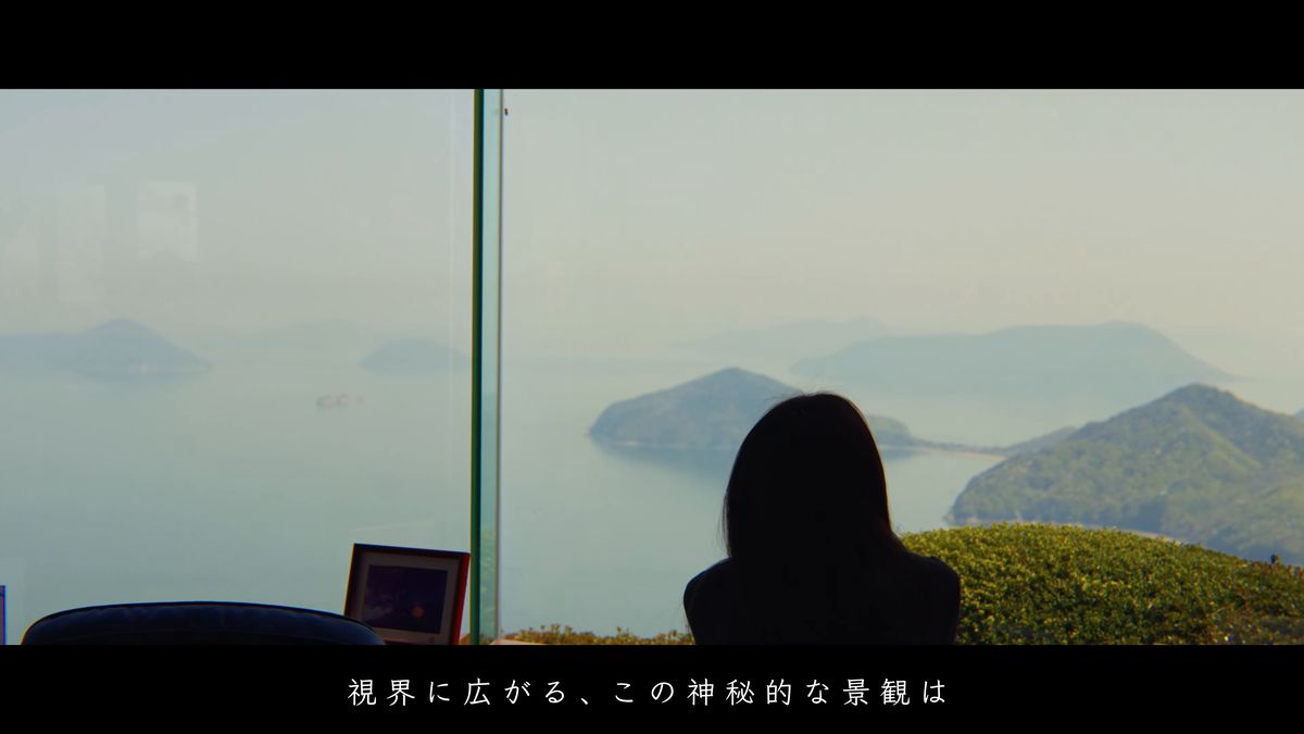 ガラス越しに島々を眺める後ろ姿