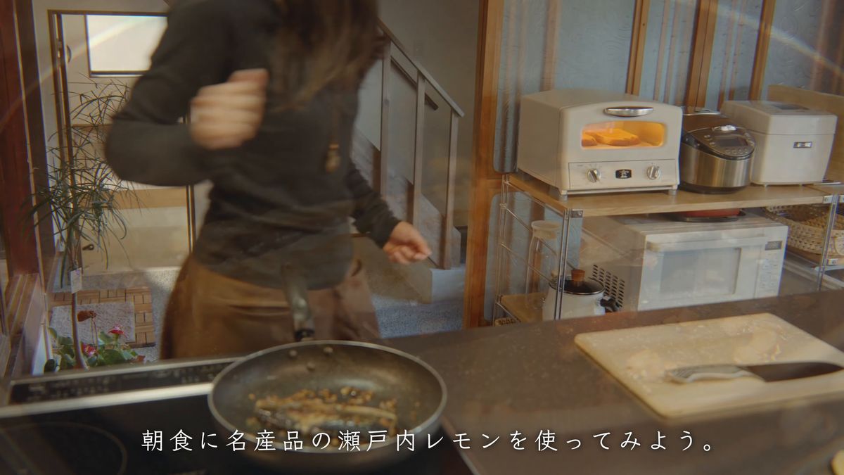 台所でフライパンを手にする後ろ姿