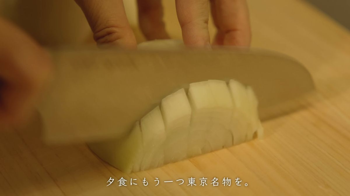 まな板の上で玉ねぎを刻む手元
